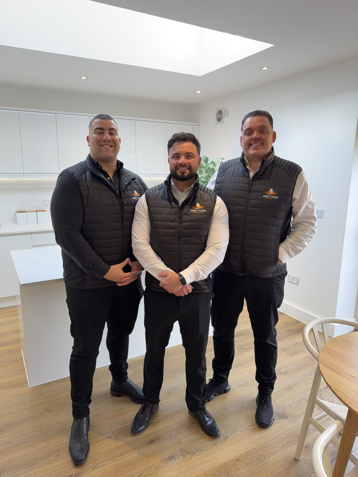 Direct Trades team standing in a completed kitchen project